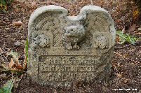 This ornate stone shows a bird of prey carved on the top