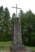 A cross stands to the rear of the church site