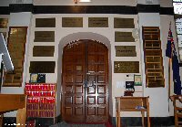 Commemorative brass plaques surround the doorway