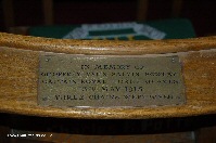 Brass plaque on chair in memory of Captain Bowlby